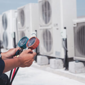 Technician is checking air conditioner ,measuring equipment for filling air conditioners.